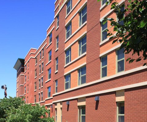 Stone and brick masonry exterior of the Casa Maravilla senior apartments